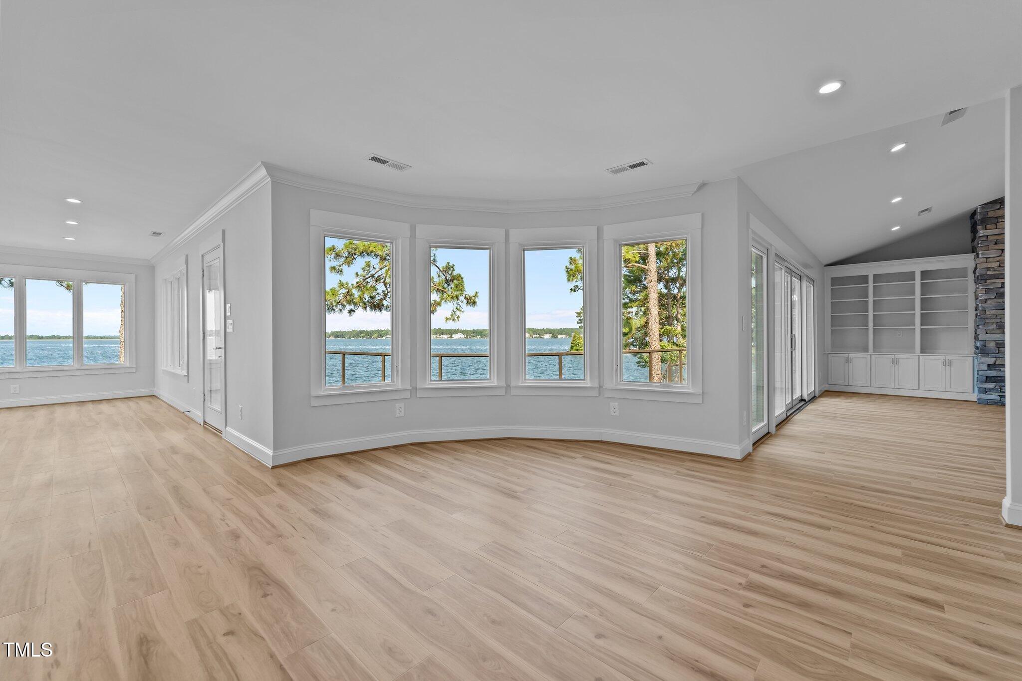 106 Mace Point West End, NC 27376 - Photo 11 of 79 a view of an empty room with wooden floor and a window