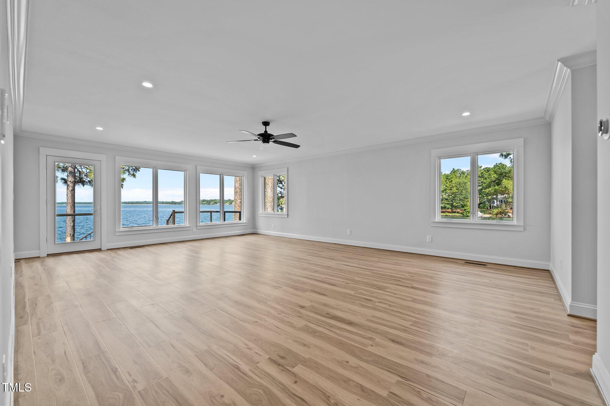 106 Mace Point West End, NC 27376 - Photo 12 of 79 a view of an empty room with wooden floor and fan