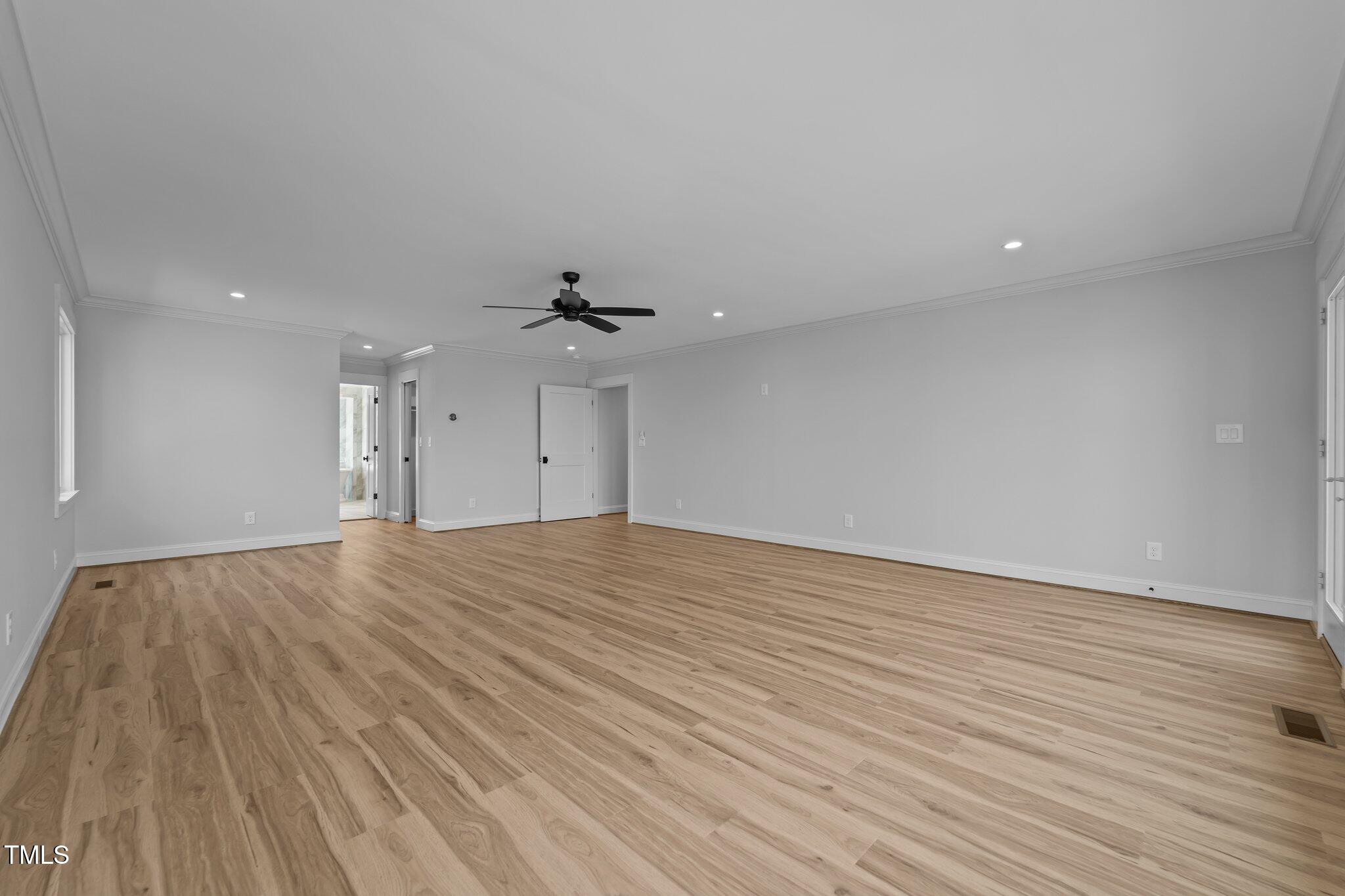 106 Mace Point West End, NC 27376 - Photo 13 of 79 a view of an empty room with wooden floor and a ceiling fan