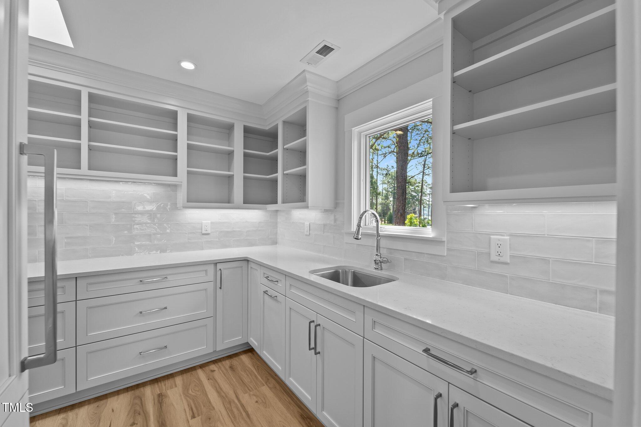 106 Mace Point West End, NC 27376 - Photo 24 of 79 a kitchen with a sink and cabinets