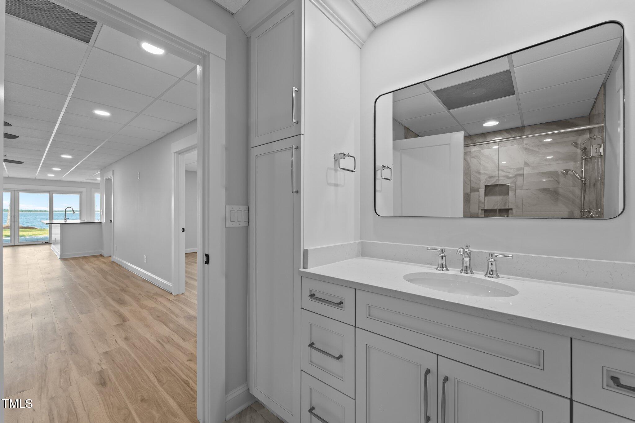 106 Mace Point West End, NC 27376 - Photo 42 of 79 a en suite bathroom with a shower sink and mirror