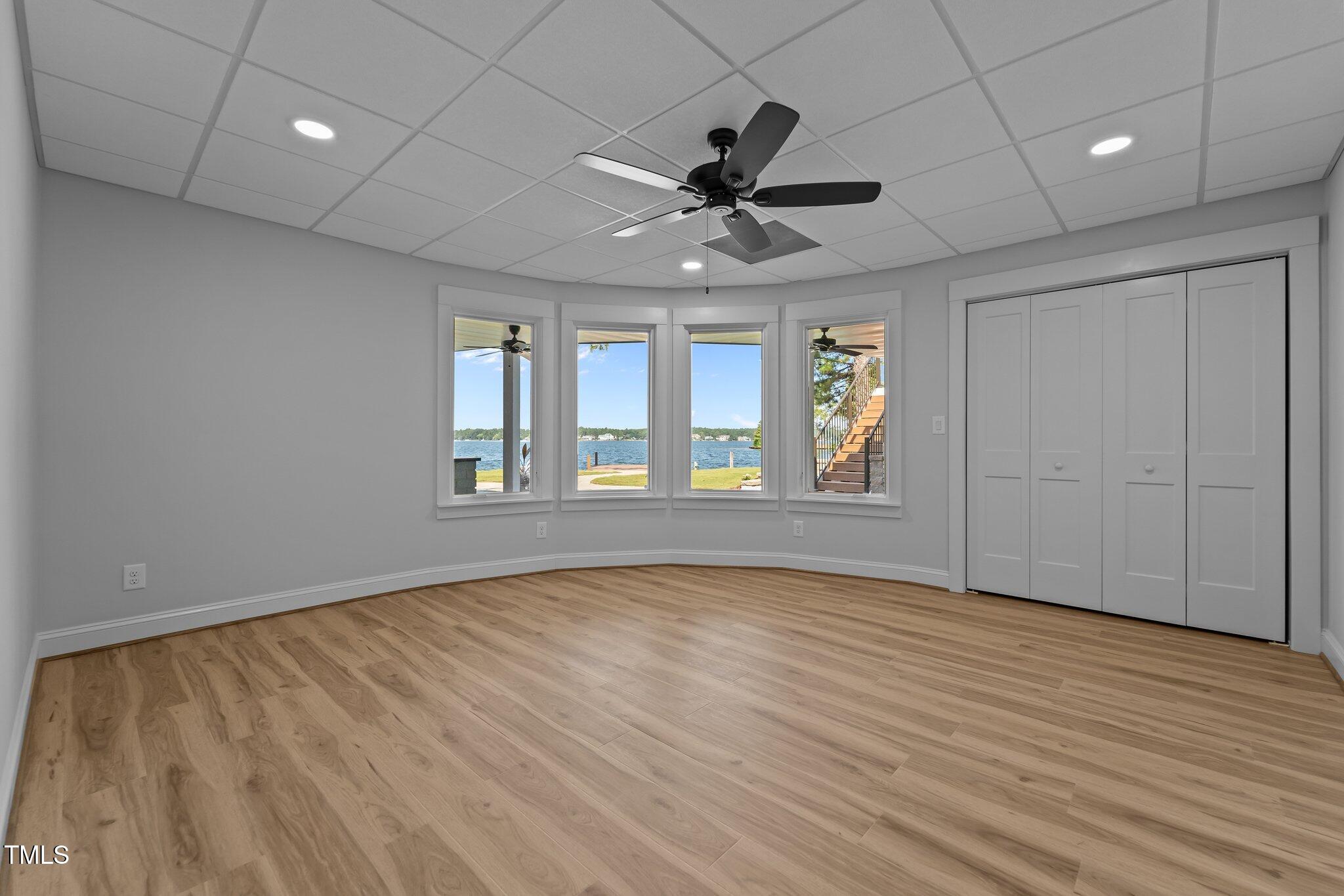 106 Mace Point West End, NC 27376 - Photo 49 of 79 a view of an empty room with a window and wooden floor