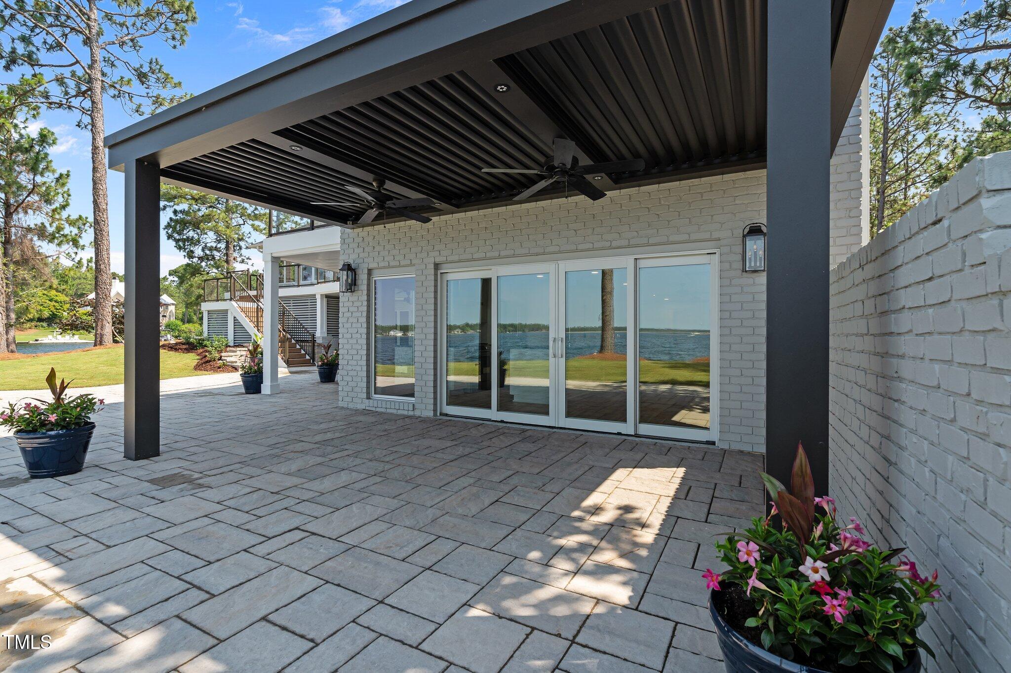 106 Mace Point West End, NC 27376 - Photo 65 of 79 a view of a porch with furniture and floor to ceiling window