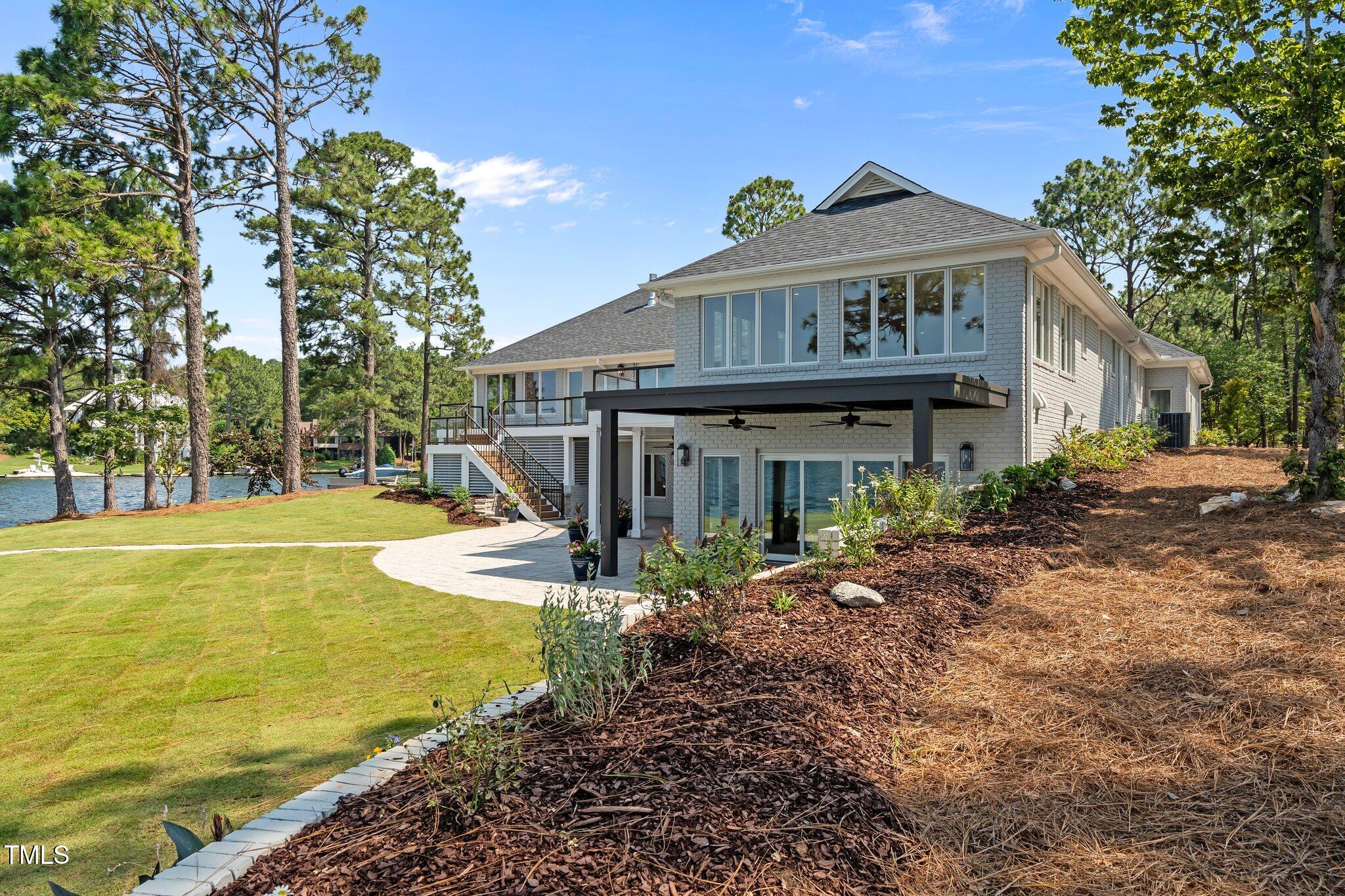 106 Mace Point West End, NC 27376 - Photo 71 of 79 a view of a house with swimming pool and sitting area
