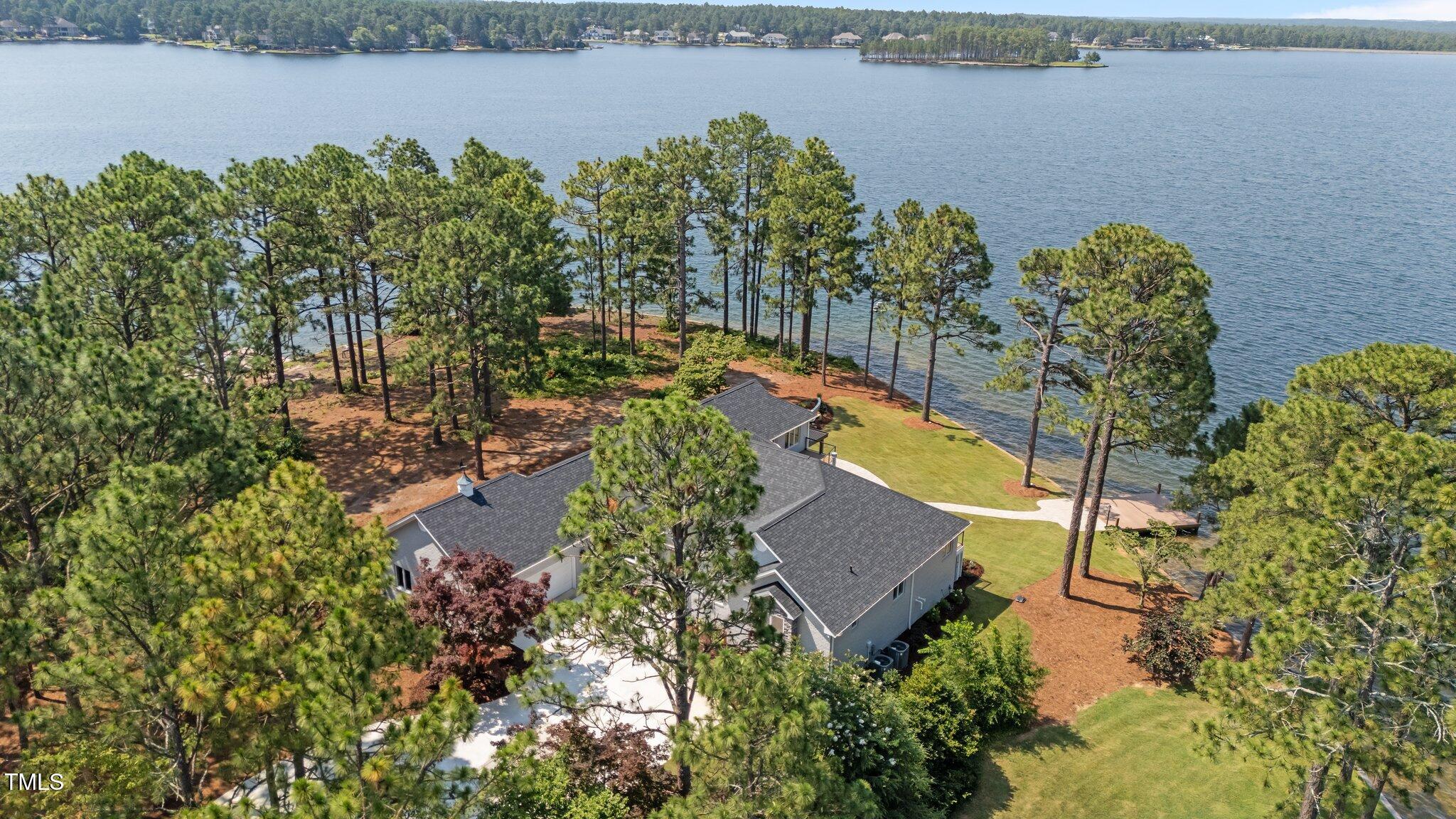 106 Mace Point West End, NC 27376 - Photo 6 of 79 a view of a lake with a building in the background