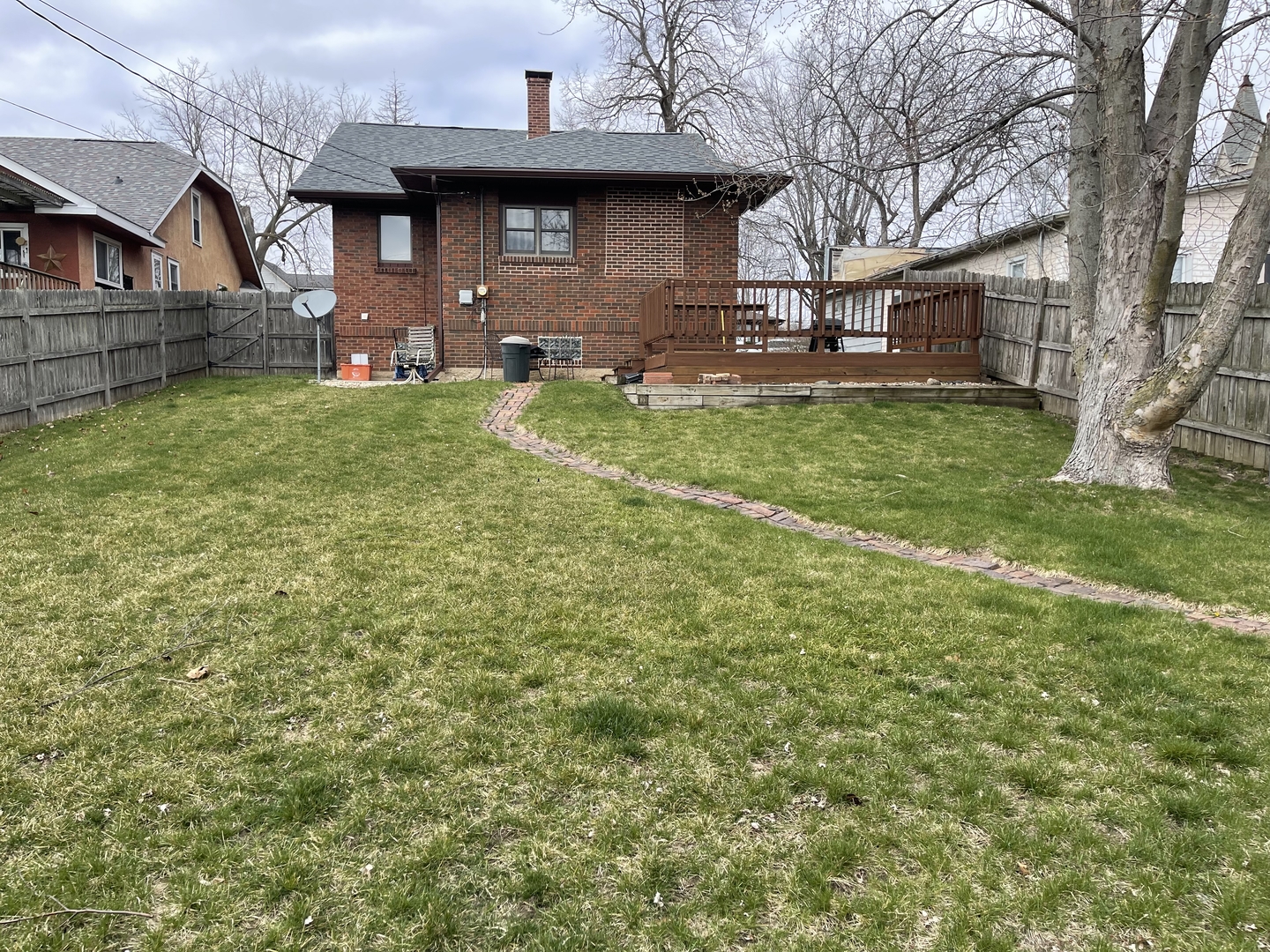 105 West 4th Street Spring Valley, IL 61362 - Photo 15 of 17 a view of a yard in front of a brick house with a large tree