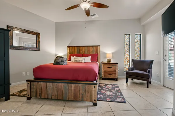 a bedroom with a bed and a chandelier