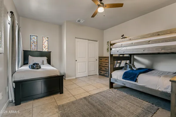 a bedroom with bed and a chandelier