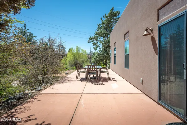 a view of a patio with table and chairs and potted plants