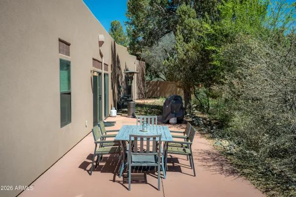 a view of backyard with furniture and a tree
