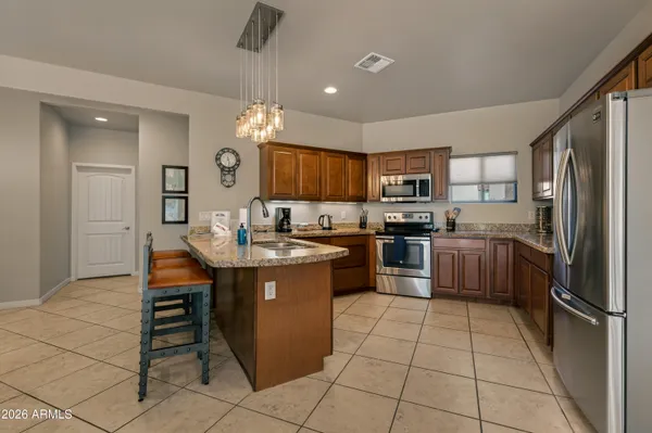 a kitchen with a sink stainless steel appliances and cabinets