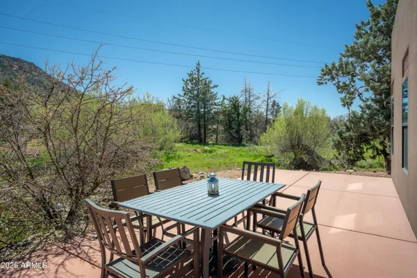 a view of a dinning table and chairs on the roof deck