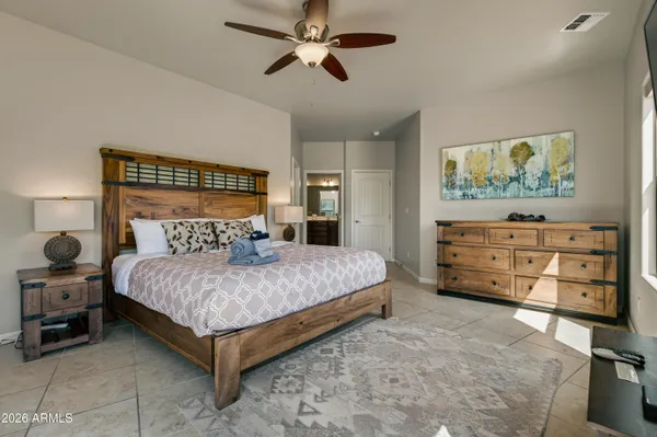 a bedroom with a bed and a chandelier