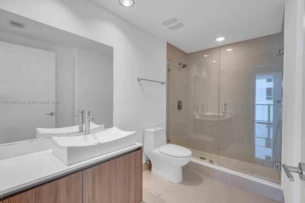201 Southwest 17th Road, Unit 302 Miami, FL 33129 - Photo 13 of 27 a bathroom with a sink toilet and shower