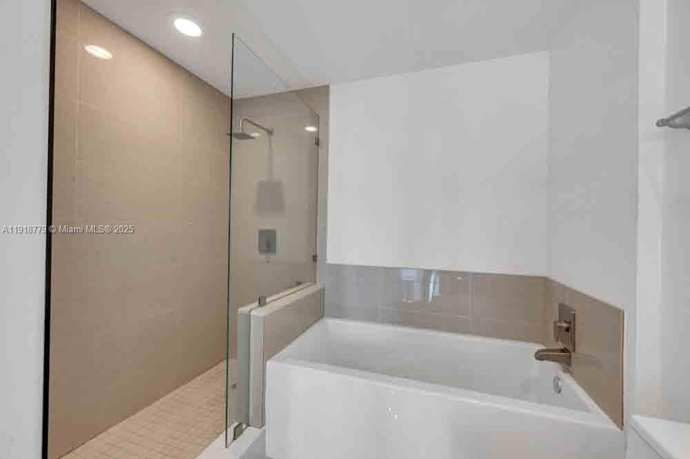 201 Southwest 17th Road, Unit 302 Miami, FL 33129 - Photo 15 of 27 a bathroom with a bathtub and a shower