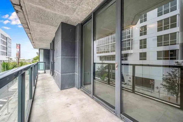 a view of balcony with wooden floor