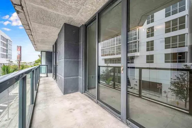 a view of balcony with wooden floor