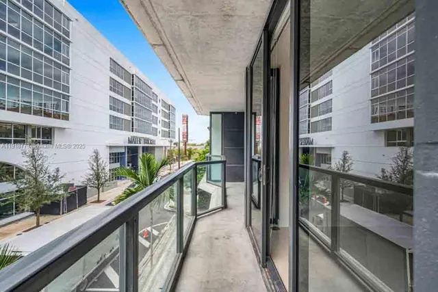a view of a building with a yard and plants
