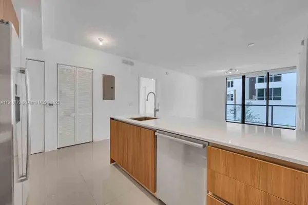 a kitchen with stainless steel appliances granite countertop a sink and cabinets