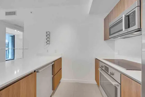a kitchen with stainless steel appliances granite countertop a sink and a granite counter tops