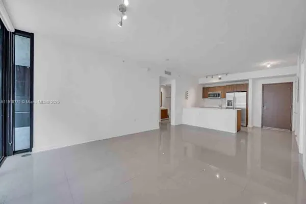 a view of a kitchen with a sink and a refrigerator