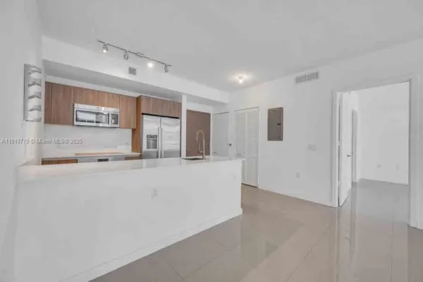 a view of a kitchen with stainless steel appliances