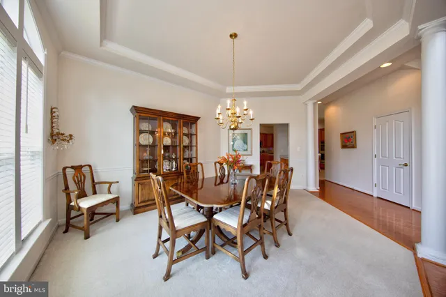 a view of a dining room with furniture and chandelier