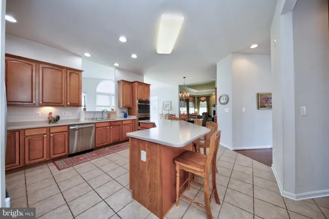a kitchen with stainless steel appliances granite countertop a sink counter space and cabinets