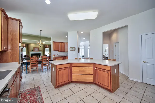 a kitchen with a sink dining table and chairs