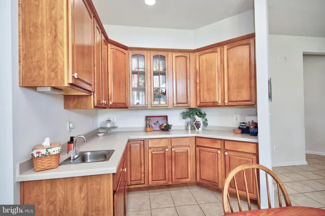 a kitchen with stainless steel appliances granite countertop a sink a stove and cabinets