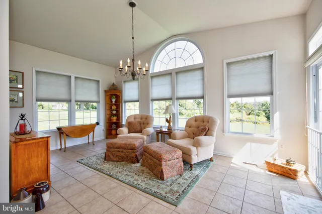 a living room with furniture large window and a fireplace