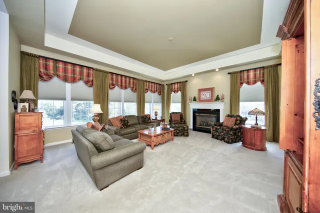a living room with furniture fireplace and flat screen tv