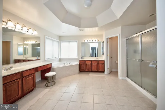 a living room with furniture and a dresser with wooden floor