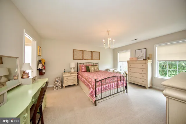 a bedroom with bed and window