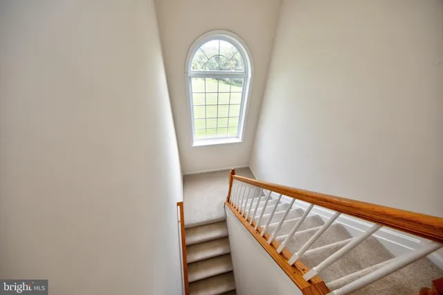 a spacious bedroom with a bed and a large window