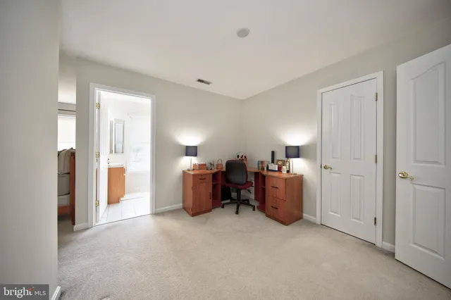 a view of a room with a dresser and workspace