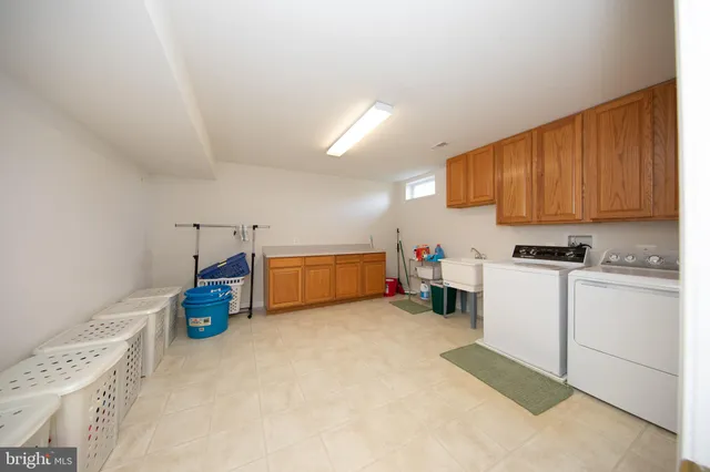 a view of a house with a big yard with large tree and plants