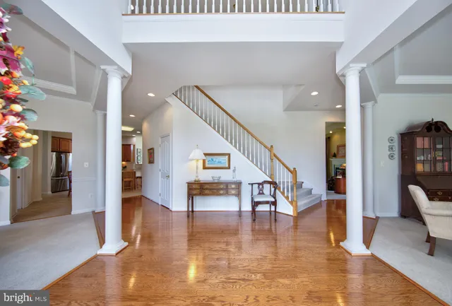 a view of an entryway with wooden floor and a livingroom view