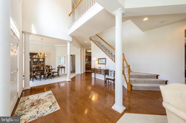a view of a hallway with wooden floor and dining room