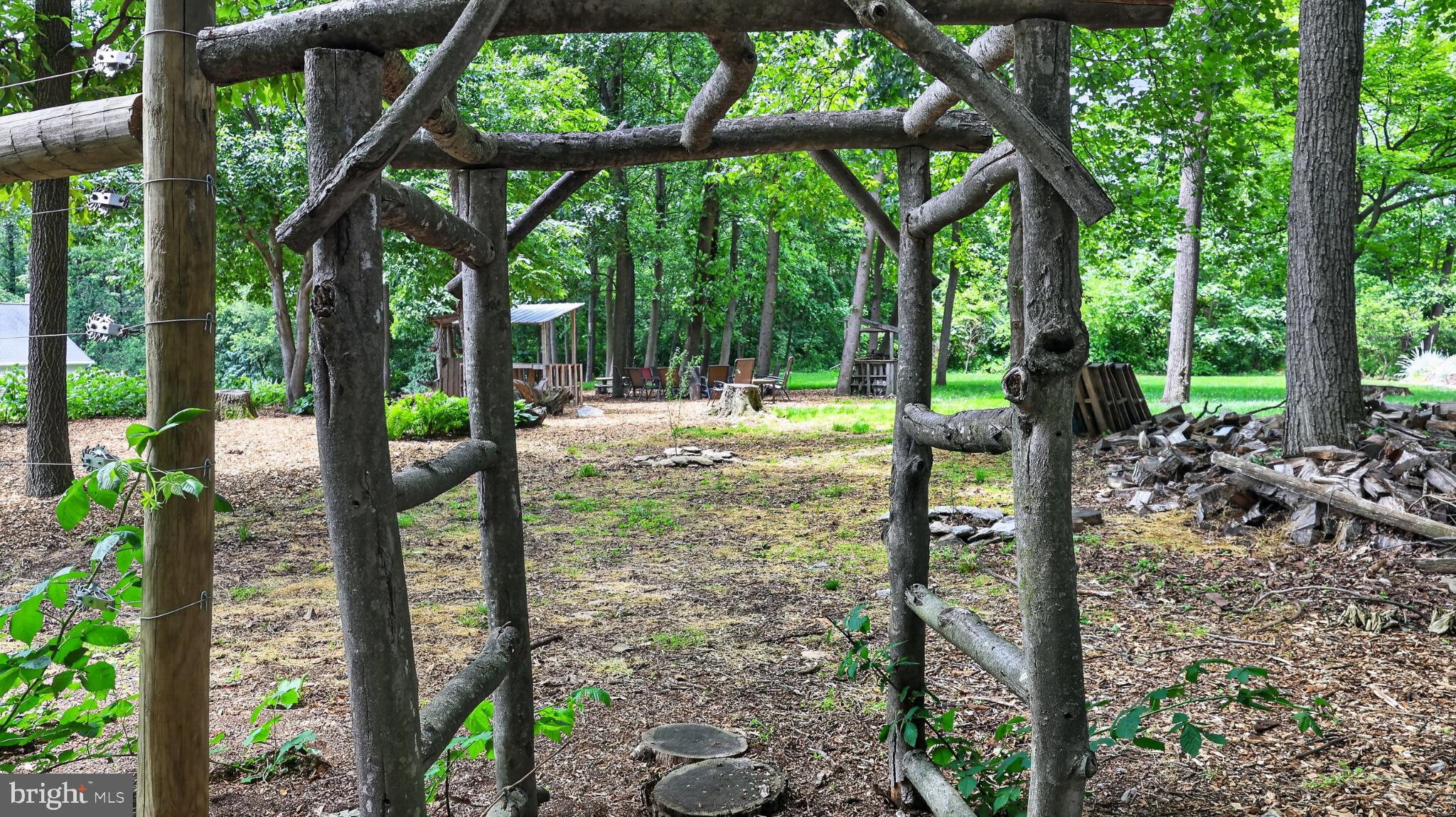 257 Hill Road New Holland, PA 17557 - Photo 29 of 94 Rustic archway in a serene garden.