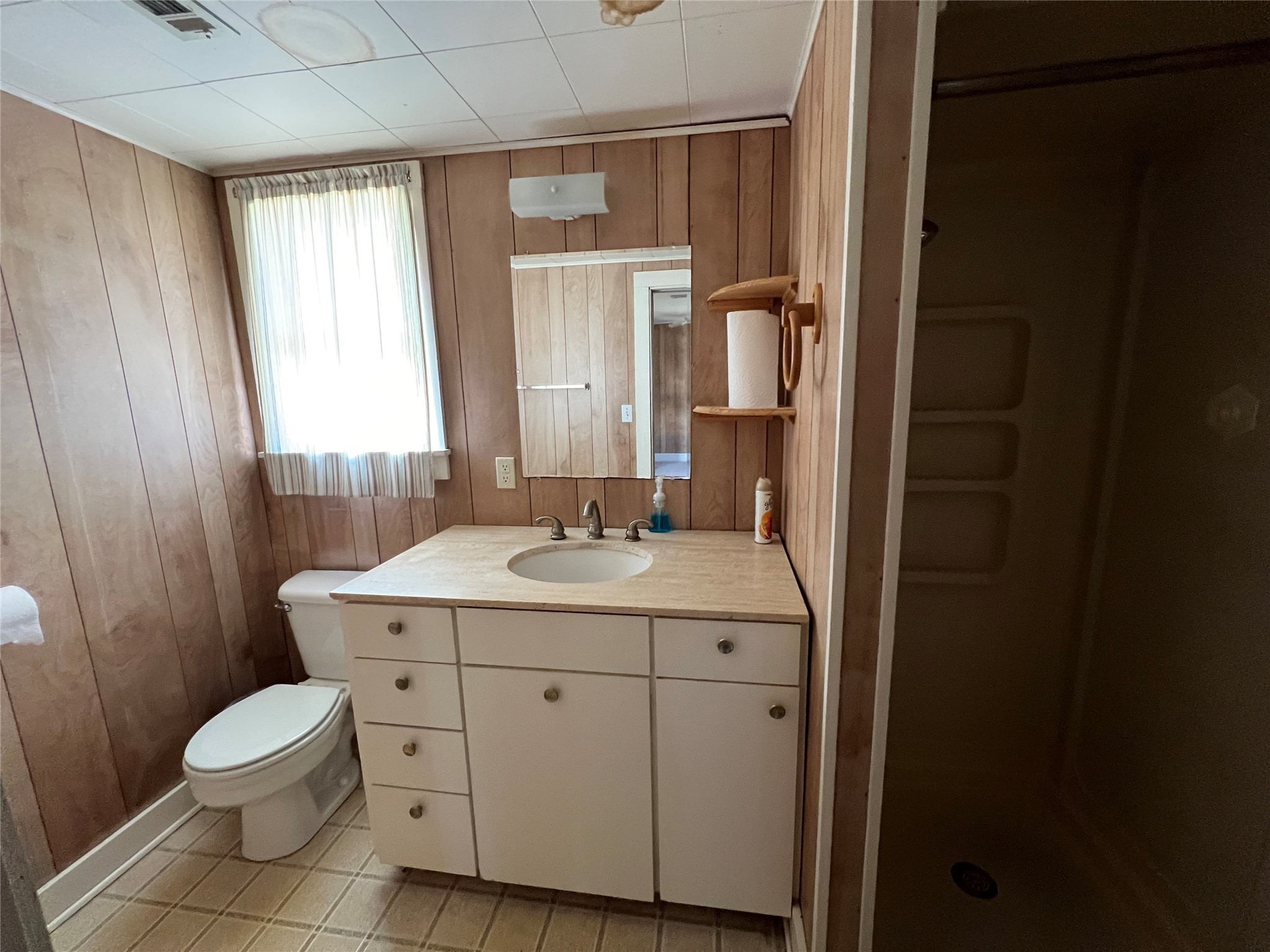 220 South Tesch Street Bellville, TX 77418 - Photo 11 of 14 a bathroom with a toilet sink and mirror
