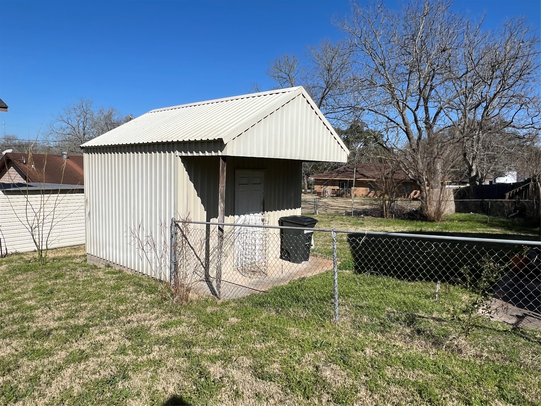 220 South Tesch Street Bellville, TX 77418 - Photo 4 of 14 a view of a backyard with a wooden fence