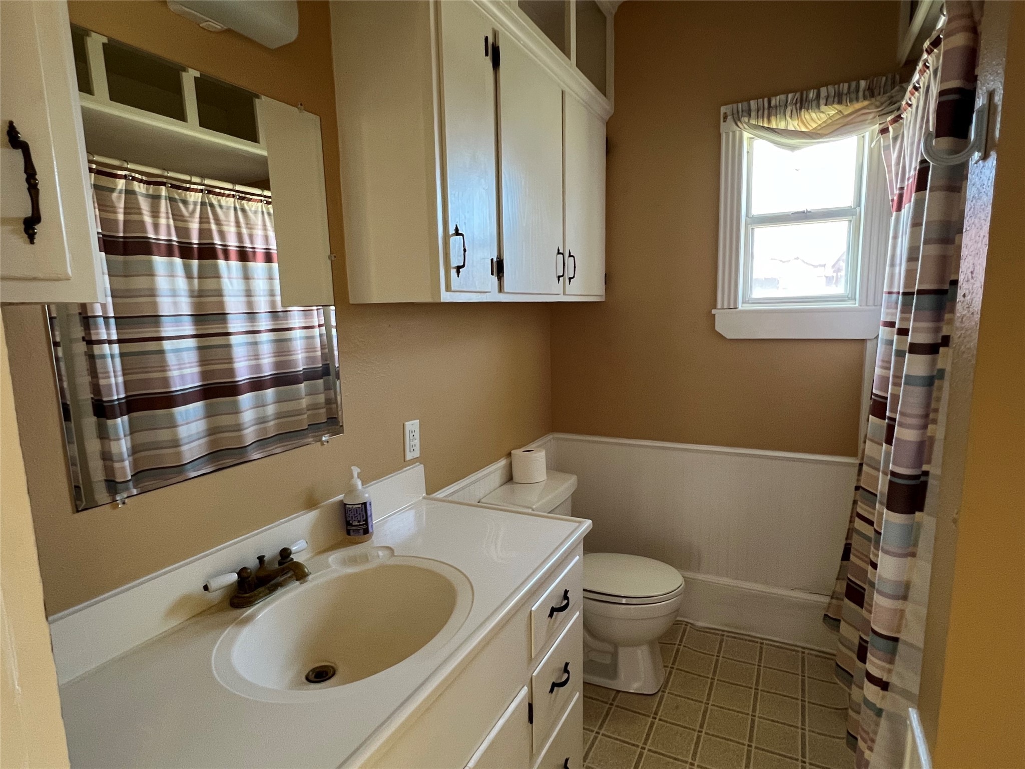 220 South Tesch Street Bellville, TX 77418 - Photo 9 of 14 a bathroom with a sink toilet and shower