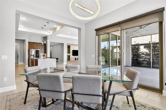 a dining room with furniture and large windows