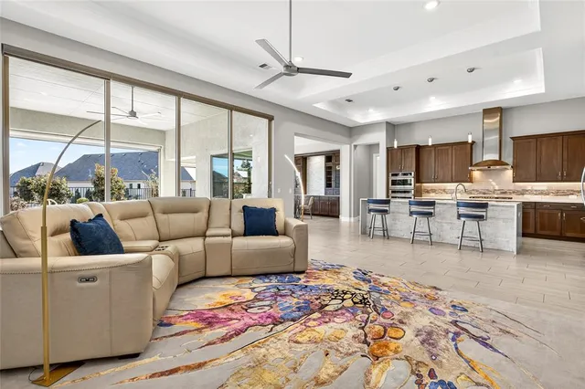 a living room with fireplace furniture and a large window
