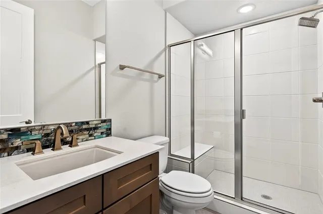 a bathroom with a sink toilet and shower