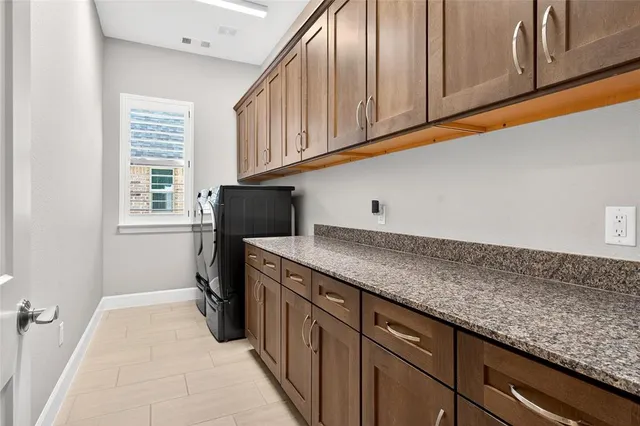 a kitchen with granite countertop cabinets and window