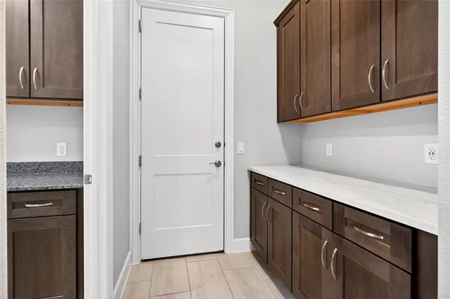 a kitchen with granite countertop cabinets and black appliances