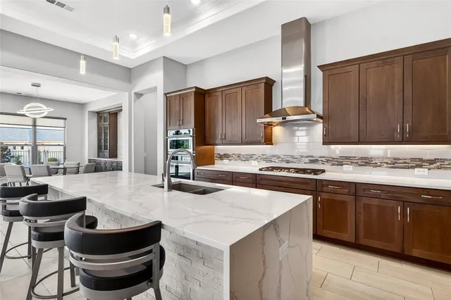 a kitchen with sink stove and cabinets