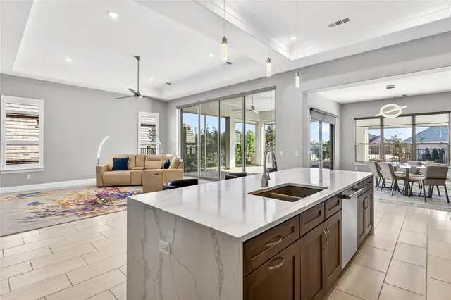 a kitchen with counter top space and windows